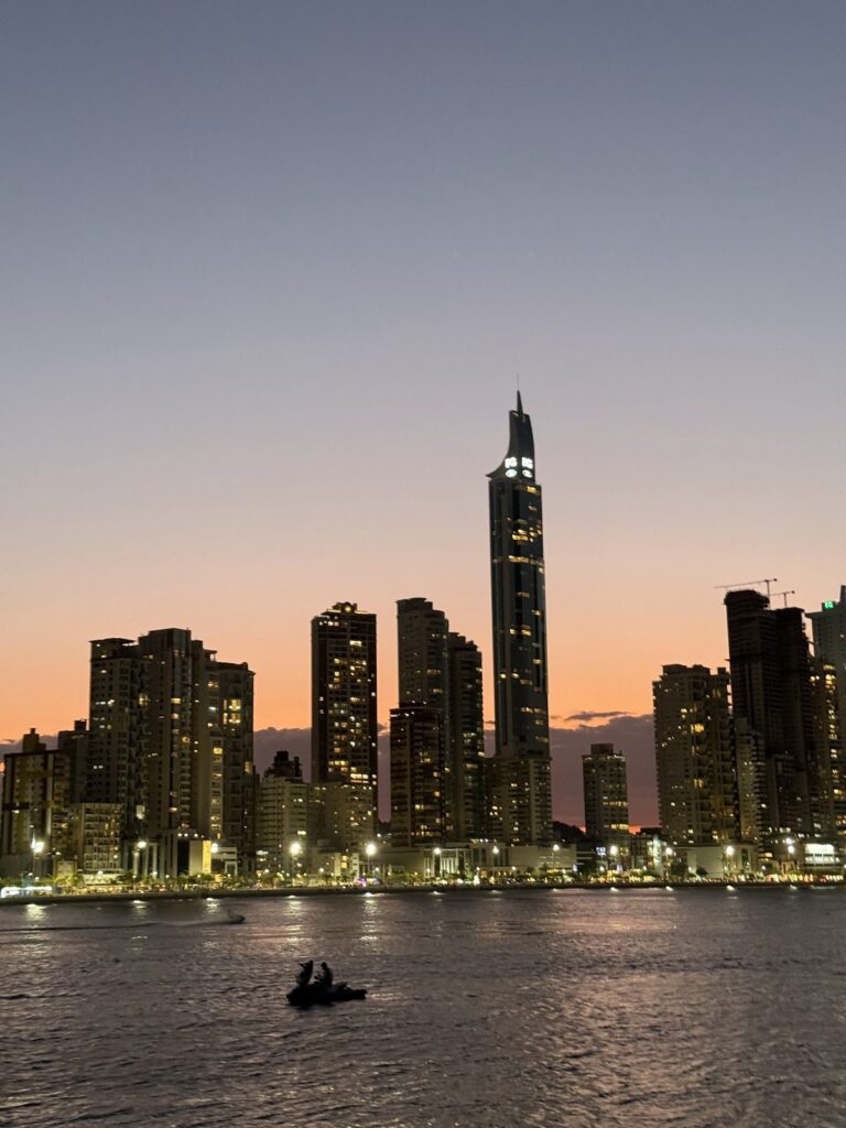 Tall towers of Barra Sul silhouetted against the sunset sky